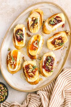 small appetizers with nuts and cranberry toppings on a platter