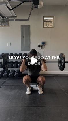 a man squats in front of a barbell with the words leave you got at the door