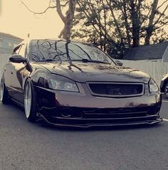 a black car parked in front of a house