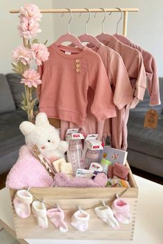 a wooden box filled with baby items on top of a table