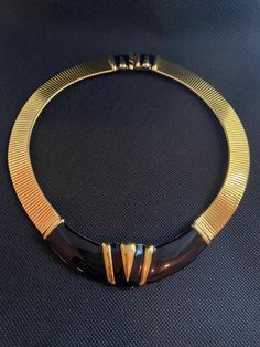 "Monet modernist omega choker, collar necklace Circa 1980's in gold tone omega chain, featuring black enamel geometric bar in a curve center, the necklace has a slide in box clasp with very nice details black enamel next to it.  This is a perfect necklace to wear day and night, excellent condition,signed Monet on the back of the enamel pendant. Measure: 18\" Long x 1\" Wide at widest point. If you have question don't hesitate to ask. Thank you for shopping at Maggiememorybox." Choker Collar Necklace, Unicorn Pendant, Black Choker Necklace, Monet Jewelry, Enamel Necklaces, Box Clasp, Flower Pendant Necklace, Choker Collar, Necklace Black