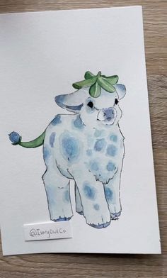 a drawing of a blue and white dog with a green bow on it's head