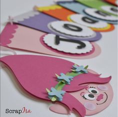 paper cut outs with numbers on them and a pink gnome's head in the middle