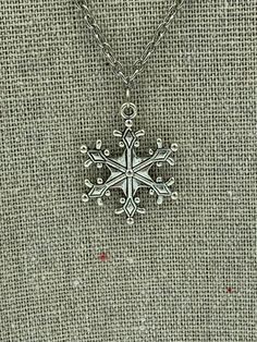 A necklace made from a large snowflake charm on a 16 inch chain. Plated Silver Necklaces For Winter Holidays, Winter Snowflake Necklace, Snowflake Necklace For Winter Holiday, Winter Holiday Snowflake Necklace, Snowflake Necklace, Snowflake Pendant, Charm Necklace, Necklace Etsy, Beauty Book