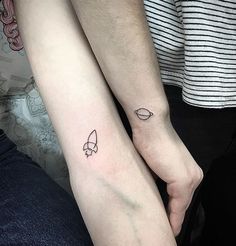 two people with matching tattoos on their arms