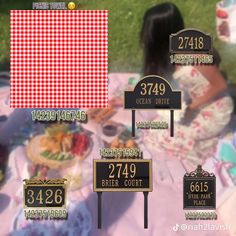 a woman sitting on top of a blanket in front of a table covered with food