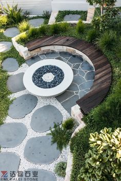 a circular bench sitting in the middle of a garden