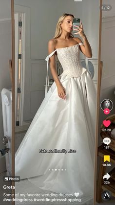 a woman in a wedding dress taking a selfie with her cell phone while standing next to a mirror