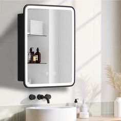 a bathroom with a sink, mirror and shelves on the wall next to each other