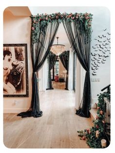 a hallway decorated with black curtains and red roses