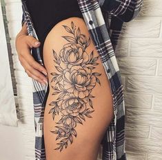 a woman's thigh with flowers on it