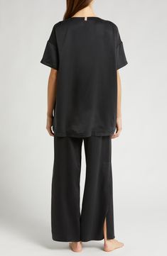 These mulberry-silk pajamas are naturally hypoallergenic, breathable and ideal for those with sensitive skin; best part—they can go in the washing machine. The elegant set pairs an oversized high-low T-shirt with flowy pants enhanced with split cuffs and side-seam pockets. Top has 28" front length, 30 1/2" back length; bottoms have 29" inseam, 25" leg opening, 12 1/2" front rise, 16 1/2" back rise (size Medium) Top has scoop neck; short sleeves; chest patch pocket; high/low hem Pants have back e Silk Tops With Relaxed Fit For Loungewear, Silk Sleepwear For Loungewear In Casual Style, Casual Silk Sleepwear For Loungewear, Casual Silk Sleepwear, Silk Sleepwear For Loungewear In Relaxed Fit, Silk Sleepwear Relaxed Fit For Loungewear, Hem Pants, Elegant Sets, Flowy Pants