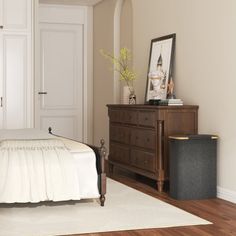 a bedroom with white walls and wooden floors