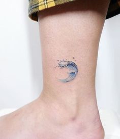 a small wave tattoo on the ankle