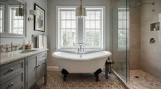 a bathroom with a claw foot tub and double sinks