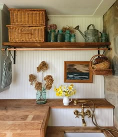 there is a sink and some baskets on the wall