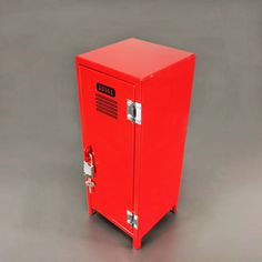 a red metal cabinet with the door open on a gray background, it appears to be empty