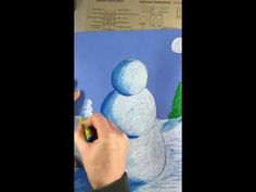 someone is drawing a snowman with colored pencils