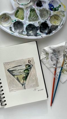 an art project with paint and watercolors on the table next to a tray