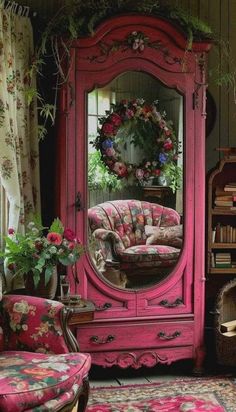 a pink armoire sitting in front of a mirror