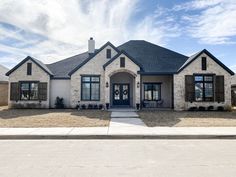 a large house with lots of windows and shutters on the front door is shown