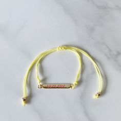 Choose who you love while you use this trendiest colorful bracelet to express it. An everyday use bracelet in cotton cord and a gold-plated plaque to tell "I Love You".Express your feeling in enchanting words on shining gold.Product specs: Adjustable cotton cord Gold-plated 18k over brass Enamel words Enchanting Words, Teddy Bear Shop, Colorful Bracelet, Instagram Gift, Who You Love, Infinity Heart, Key To My Heart, 30 Gifts, Anklet Bracelet