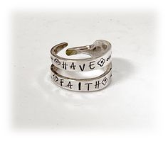 two silver rings with words on them that say, have faith and be brave in sterling