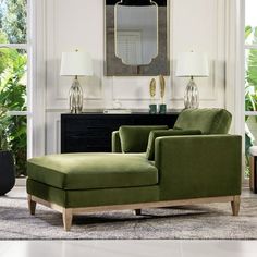 a living room scene with focus on the green chair and footstool in the foreground