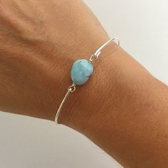 Larimar Nugget Bead Bracelet -  Light Blue Bracelet Bangle. Each Larimar nugget is a little different in its light blue color placement and faint white veining but all of them are incredible. They remind me of light foamy ocean waves. Each bead is about 14mm in size and will be transformed into an elegant Larimar beaded bangle bracelet with your choice of bangle band in sterling silver, silver filled, brass, 14k gold filled or 14k rose gold filled. This Blue Larimar jewelry can be personalized w Larimar Bracelet Jewelry Gift, Aquamarine Bracelet Jewelry As A Gift, Aquamarine Bracelet Jewelry Gift, Handmade Adjustable Larimar Bracelets, Turquoise Larimar Bracelet, Adjustable Amazonite Jewelry, Turquoise Larimar Bracelets As A Gift, Turquoise Larimar Bracelets For Gifts, Adjustable Blue Larimar Jewelry