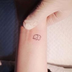 a small elephant tattoo on the wrist