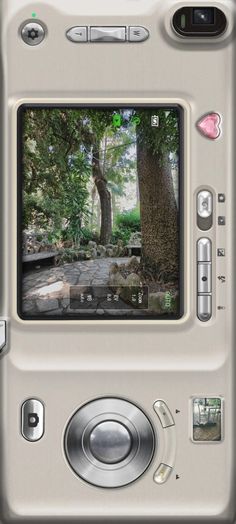 an image of a camera with trees and rocks in the backgrounnds