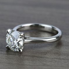 a close up of a diamond ring on a table