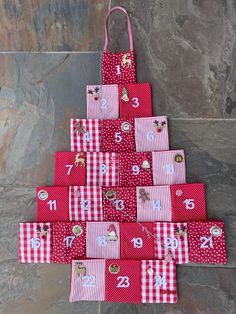 a christmas tree made out of red and white checkered fabric with numbers on it