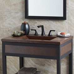 a bathroom sink with two faucets and a mirror on the wall above it