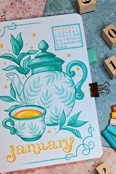 a teapot with the word january written on it next to some crayons