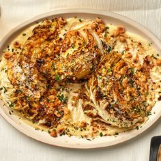 a white plate topped with meat covered in sauce