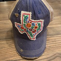 Handmade Texas Floral Patch on Vintage Blue Distressed Hat.  Snap Back Blue Country Style Hat, Country Style Blue Hat, Distressed Blue Hat With Adjustable Fit, Adjustable Distressed Blue Hat, Bohemian Distressed Summer Hats, Distressed Blue Hat For Summer, Bohemian Trucker Hat For Spring Festival, Distressed Cap For Spring, Casual Blue Trucker Hat For Festival