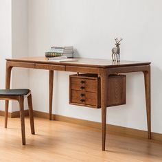 a wooden desk with two drawers and a chair next to it