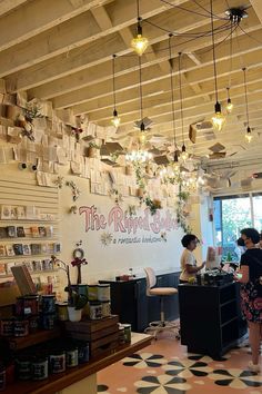 the inside of a coffee shop with hanging plants