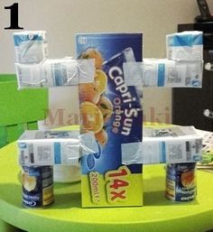 four cans of water sitting on top of a green table