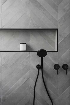 a black and white photo of a shower head with thermostaer attached to it