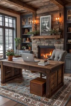 a living room with a fireplace and a laptop on a desk in front of a fire place