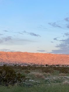 a view of the desert with mountains in the background