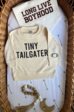 What's a better way to transition into football season than with a football bodysuit, t-shirt, or Crewneck for your tiny tailgater? Snag a super cozy option for those Saturday's & Sunday's of watching football on the couch with the family! Makes for a perfect fall baby shower gift! These bodysuits, crews & t-shirts are available in long and short sleeve style - they are a Poly/Cotton blend (65/35). They are all a light weight material perfect for layering and alone on warmer fall days! Available Fall Football Shirts, Toddler Football Shirts, Football Vinyl Shirts, White Soft-washed Tops For Game Day, Soft-washed Long Sleeve Top For Game Day, Football Graphic Tees, Football Baby Announcement, Fall Tshirt Ideas, Toddler Tshirt Ideas