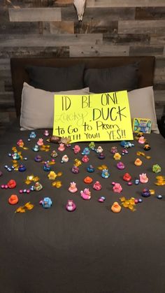 a bed topped with lots of colorful buttons next to a sign that says i'd be on duck