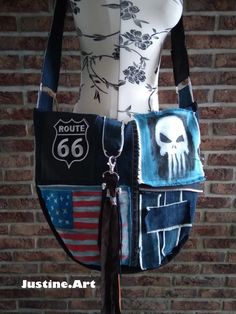 a woman's purse made out of old jeans and other fabric material with skulls on it