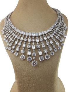 Adastra has a wide variety of cubic zirconia diamond necklace for women to choose from. This gorgeous CZ diamond necklace is in 925 sterling silver. SKU: AANC_015 Base Metal: Hypoallergenic 925 Sterling Silver (No Nickel, No Lead, No Cadmium) Metal Plating: Rhodium Stone 1: AAAAA Grade Cubic Zirconia Diamond (Very shiny - does not fade) Duty & Taxes are the buyer's responsibility. We can custom make any jewelry in 925 Sterling Silver / 18K Solid Gold / 14K Solid Gold / 10K Solid Gold. Click Mess Luxury Dazzling Halo Design Necklace, Bridal Diamond Necklace With 17 Jewels, Luxury Sterling Silver Hand Set Necklaces, Luxury Round Bridal Necklace With Sparkling Stones, Luxury White Gold Crystal Bridal Necklace, Hallmarked Diamond Necklace For Party, Dazzling Hand Set Sterling Silver Necklaces, Luxury Wedding Pendant Necklace, Party Bridal Necklace With 17 Jewels In Sterling Silver