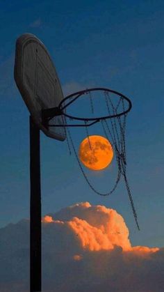 a basketball hoop with chains hanging from it's side in front of the moon