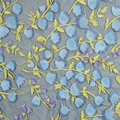 blue and yellow embroidered flowers on gray fabric