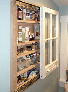 an open medicine cabinet in the corner of a bathroom